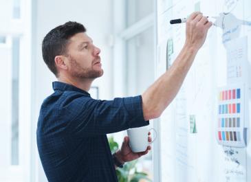Man writing at whiteboard