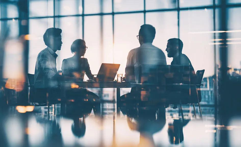 Decorative image of people in a meeting. 