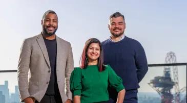 Three people standing in a row