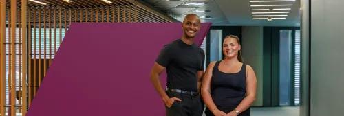 Two coworkers standing by spotlight