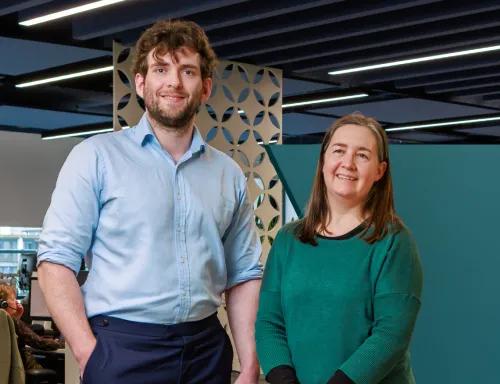 Two people standing by spotlight