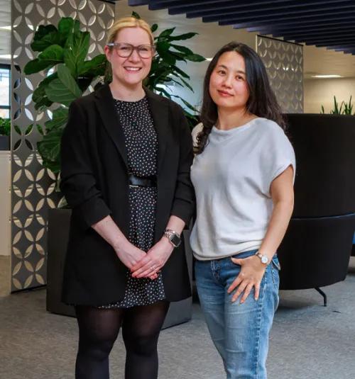Two coworkers standing