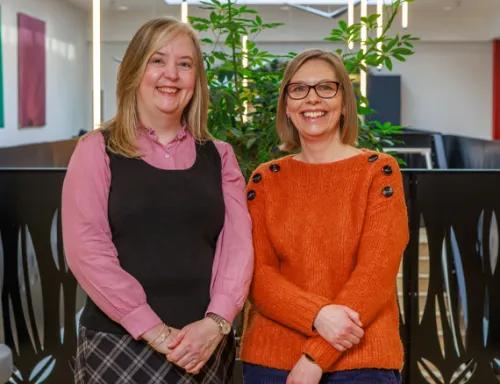 Two coworkers standing