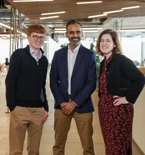Three people standing in a row